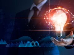 Businessman holding light bulb and brain network with icon business and technology, innovative in futuristic, network connection on interface background, abstract, innovation and technologies.